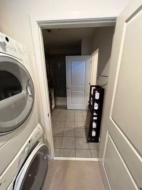 In-condo full size washer and dryer in hallway leading to bathroom.  