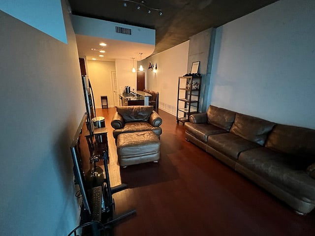 View from living room looking into the kitchen and hallway to condo entrance.  