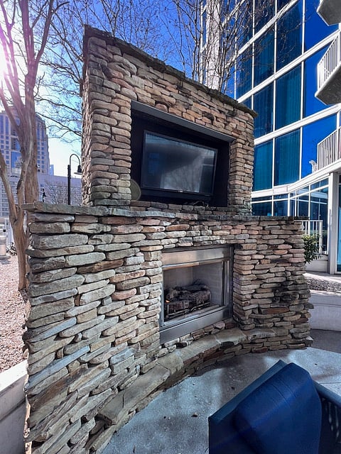 Ten-floor building amenity, outdoor fire plance and entertainment area next to the pool.  