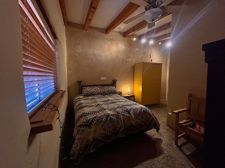 Bedroom with wardrobe and dresser. Closet located in adjacent hallway.