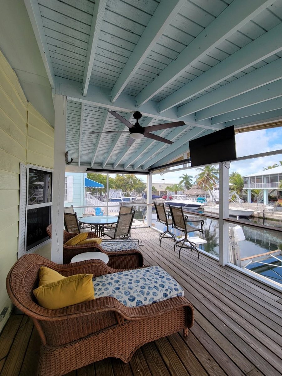 Waterfront screened in porch with TV.  The perfect place for morning coffee or sunset cocktails. 