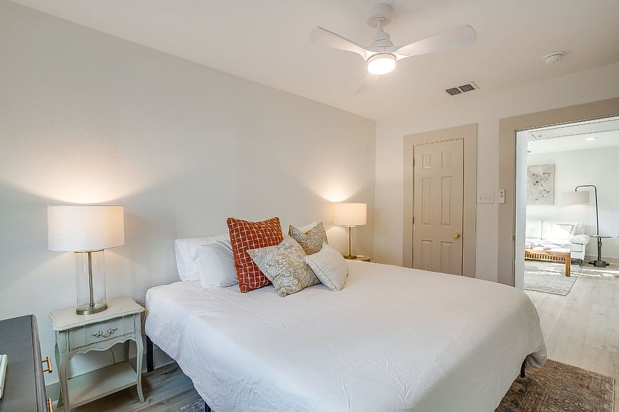 Primary bedroom with king-size bed, walk-in closet
