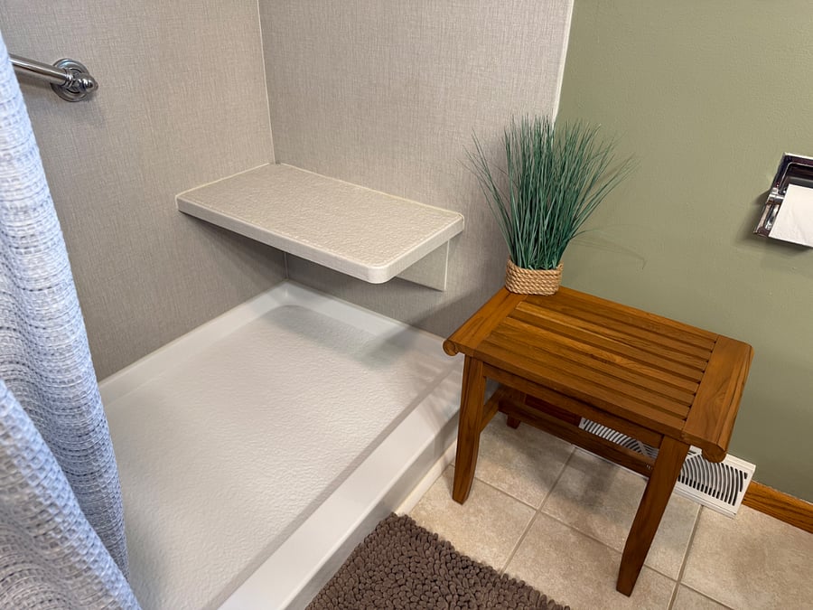 Walk-in Shower and Bench with dual rain shower heads, seating bench, and hand bars.