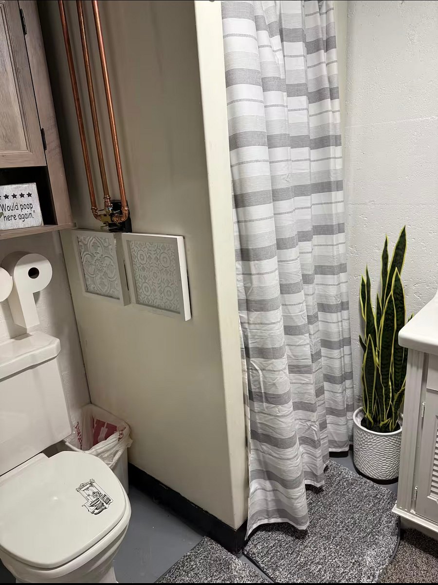 Basement Bathroom with stand-in sEhower, toilet, and vanity.