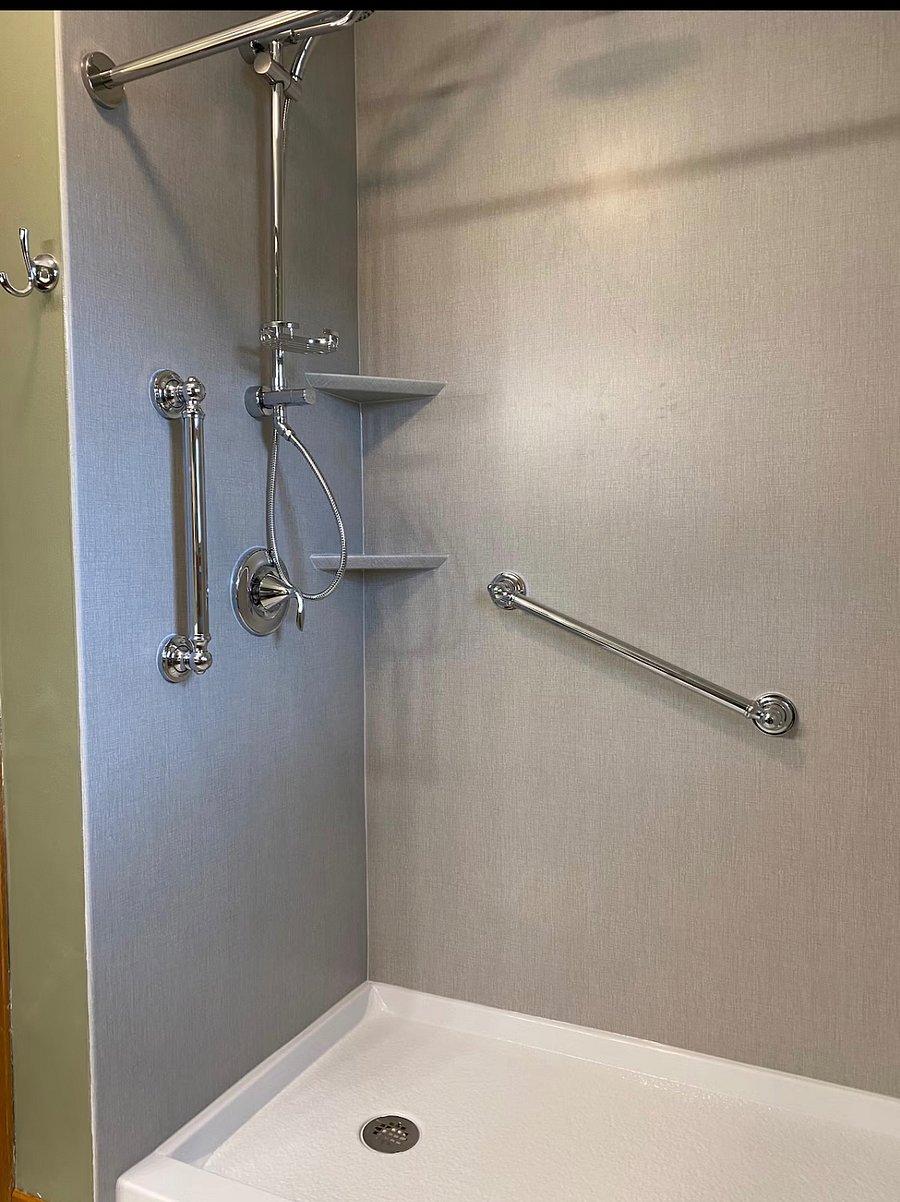 Walk-in Shower and Bench with dual rain shower heads, seating bench, and hand bars.