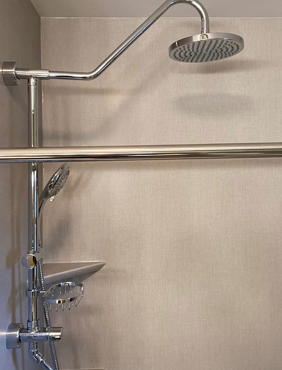 Walk-in Shower and Bench with dual rain shower heads, seating bench, and hand bars.