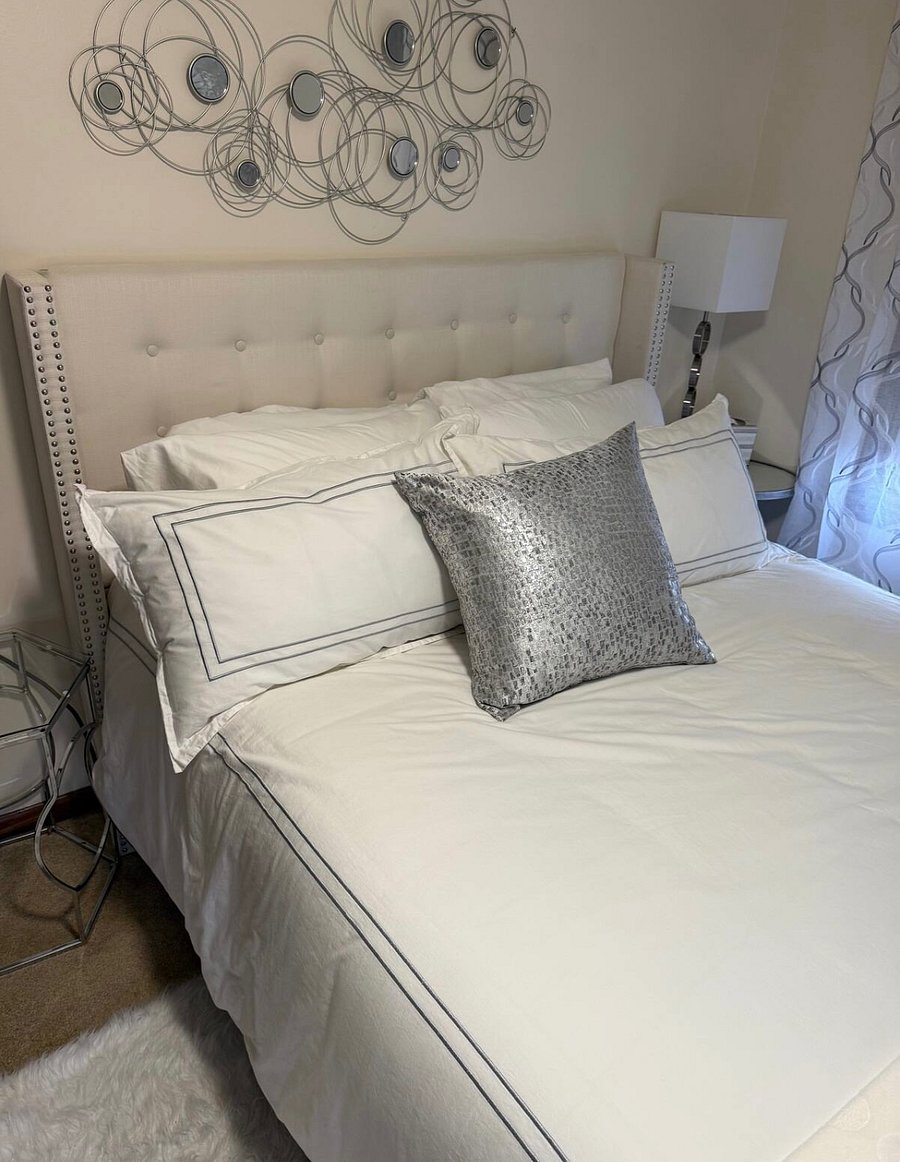Luxury Queen Size Bed with pillow top mattress and 4 luxury pillows.  Each room contains full size mirror, closet with hangers, chair, bench, dresser, lamps, alarm clock with USB, and ceiling fan.