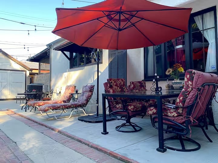 Enclosed private patio with lounge and dining areas. Safe for pets