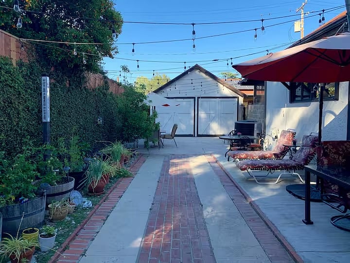 Enclosed private patio with lounge and dining areas. Safe for pets