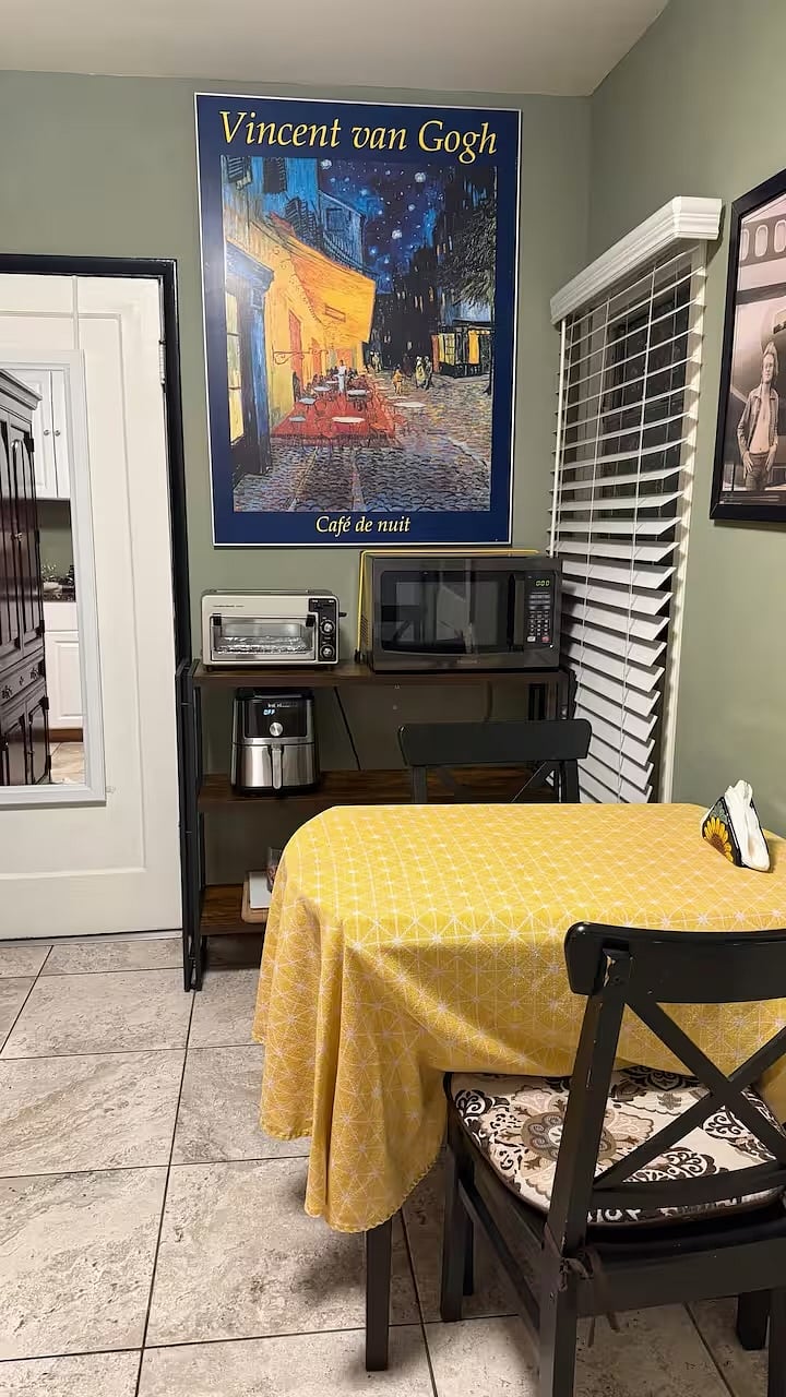 Dining area with toaster oven, microwave, air flyer. There are also hot plates and an electric fryer. 