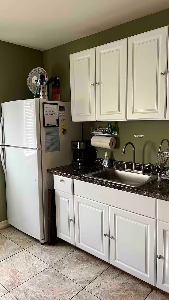 Kitchenette with full-size refridgerator, coffee maker and sink. 
