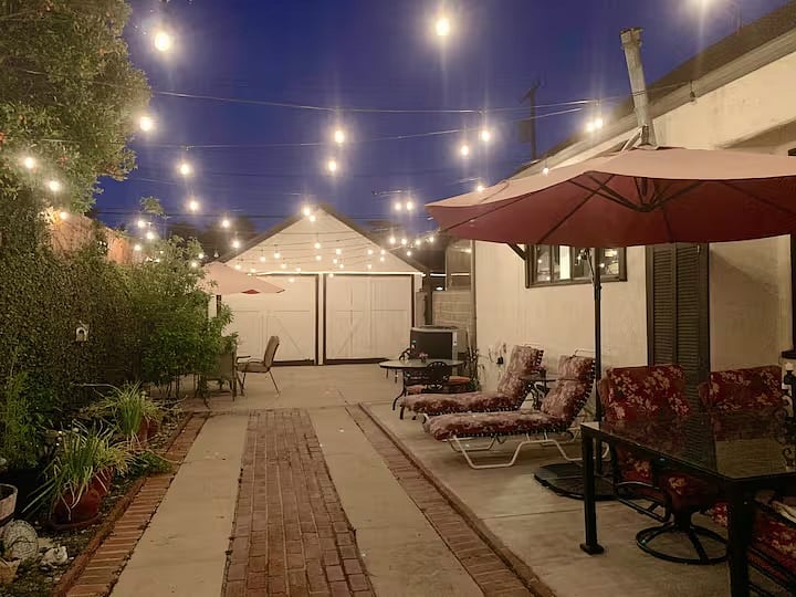 Bistro lights in enclosed private patio with lounge and dining areas. Safe for pets.