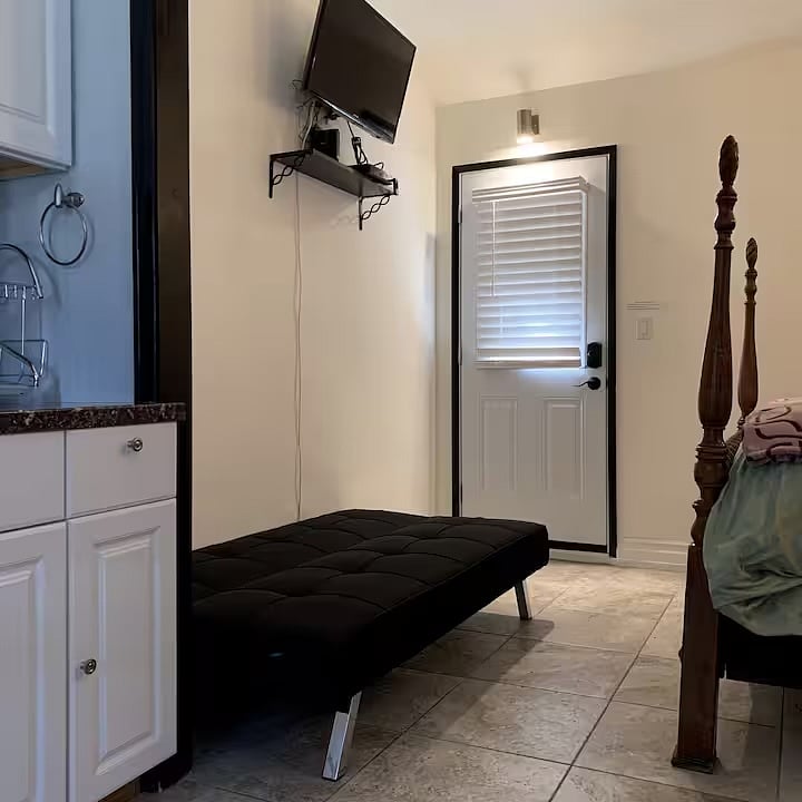 Futon sofa that pulls down to twin size bed. Not for tall adults.