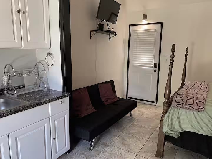 View from kitchenette to bedroom and entrance.