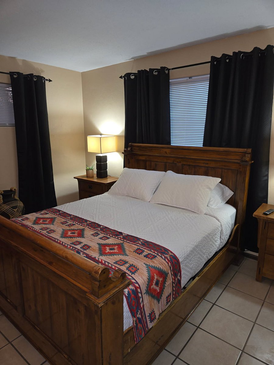 Bedroom 3. Queen Bed, full dresser, 2 end tables with drawers,  closet with overhead and vertical shelving, luggage stand, hamper, smart TV, bedside lamps,  windows with blinds and black out drapes, white noise machine.