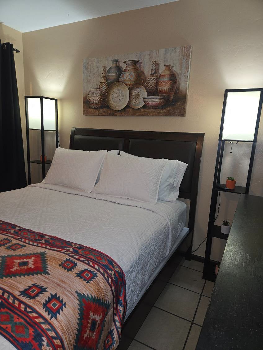 Bedroom 2. Queen Bed, full dresser, closet with overhead shelving, luggage stand with 2 drawers, hamper, smart TV, bedside lamps,  window with blinds and black out drapes, white noise machine.