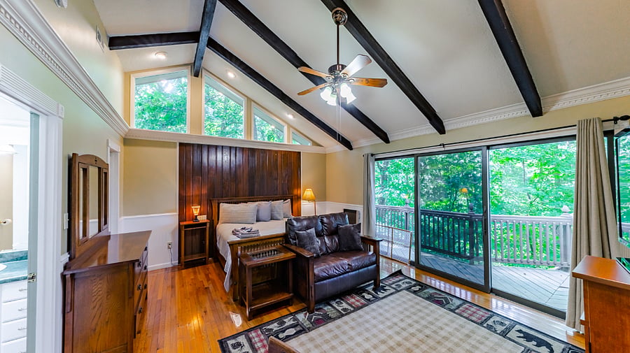 Primary bedroom with king bed, sitting area and deck access