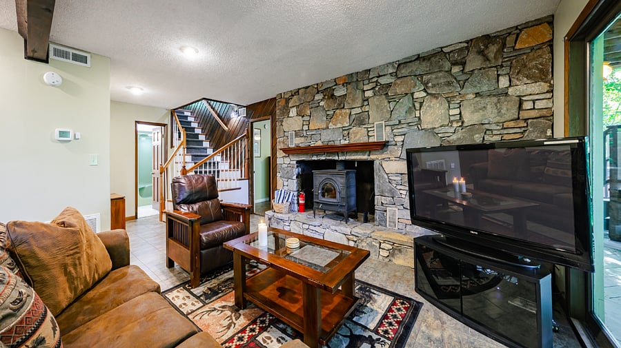 Downstairs living room with stone fireplace