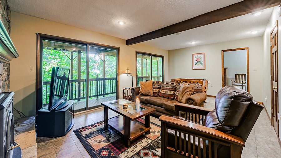 Downstairs living area with seating and deck access