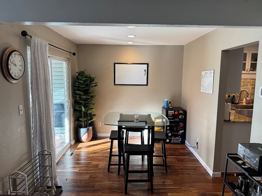 Open dining room situated between the kitchen and backyard patio.