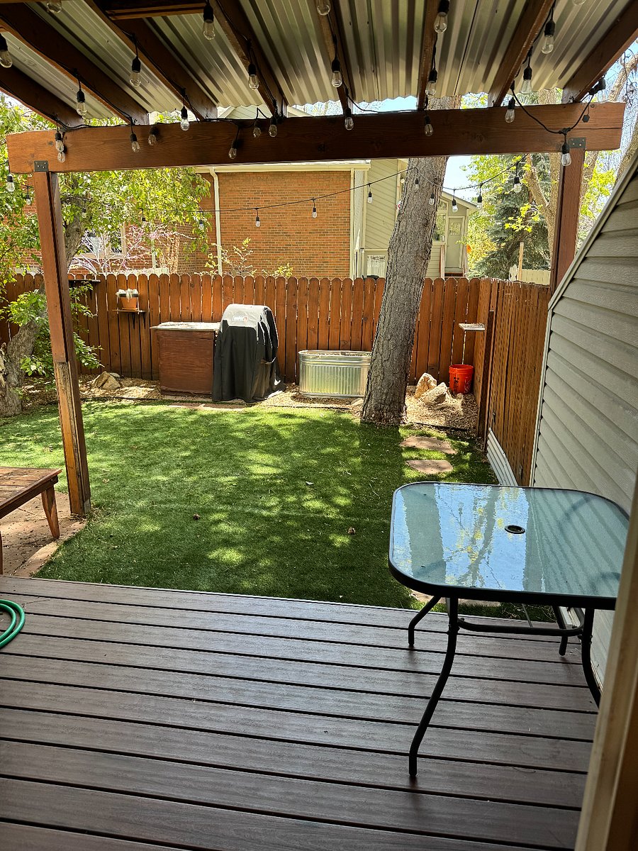 Inviting backyard, with turf grass and gravel. Great for pets.