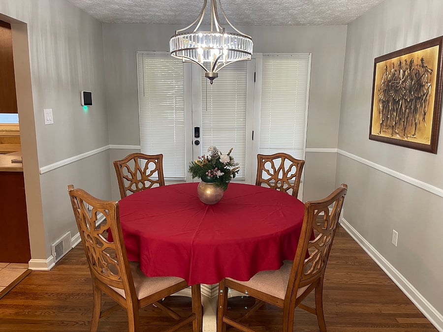 Dining room facing doors to screened porch, patio, and carport