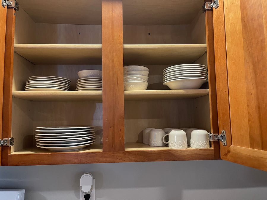 kitchen cabinet showing dishes provided