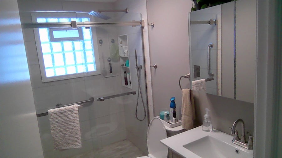 Bathroom with walk in shower and bluetooth lighting and medicine cabinet.