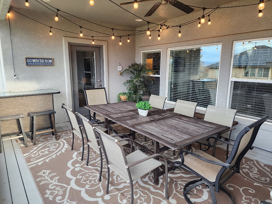 Deck off kitchen with stairs leading to backyard