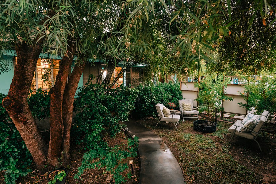 Frontyard entry and seating around fire-pit.