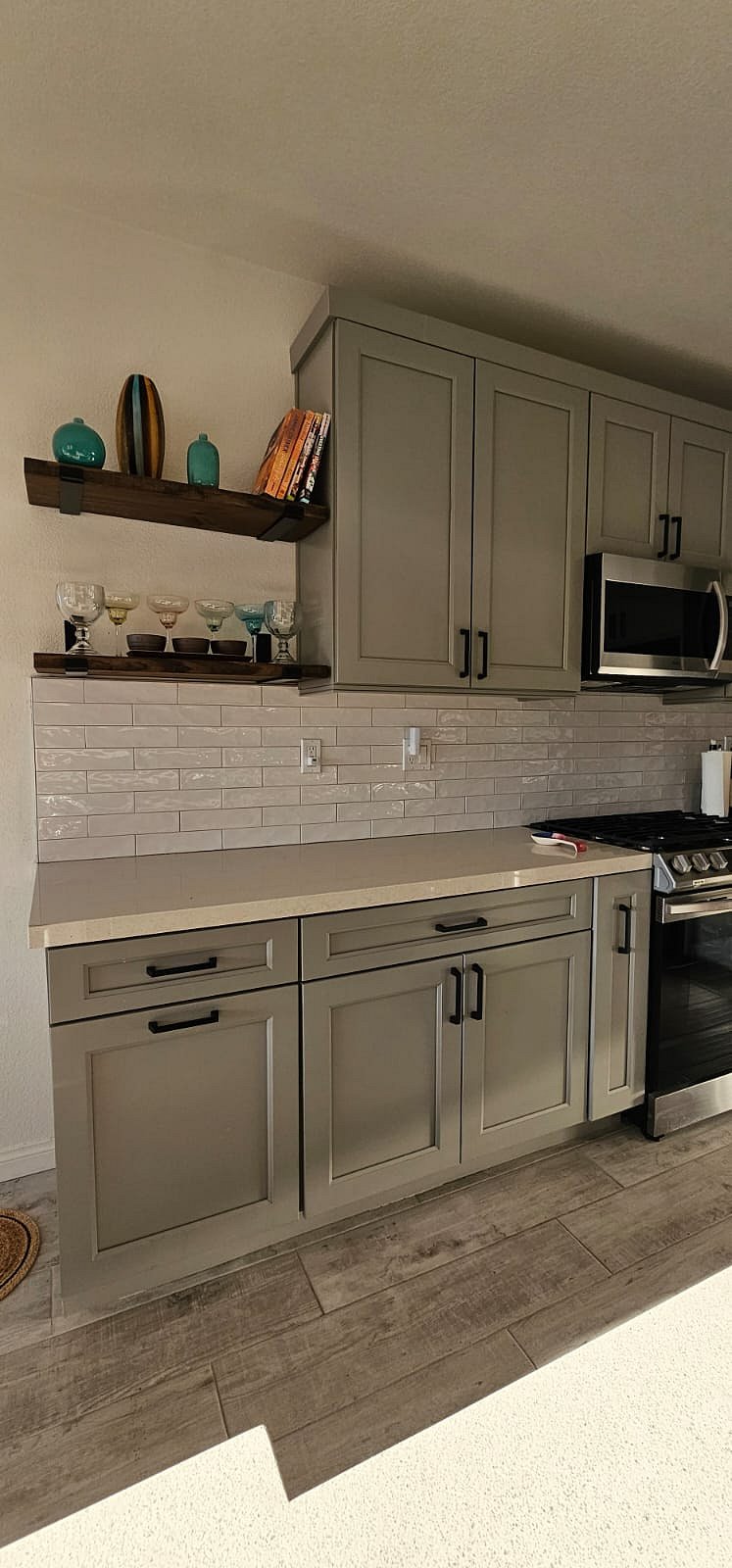 fully remodeled kitchen with floating shelves and subway tiles. 
