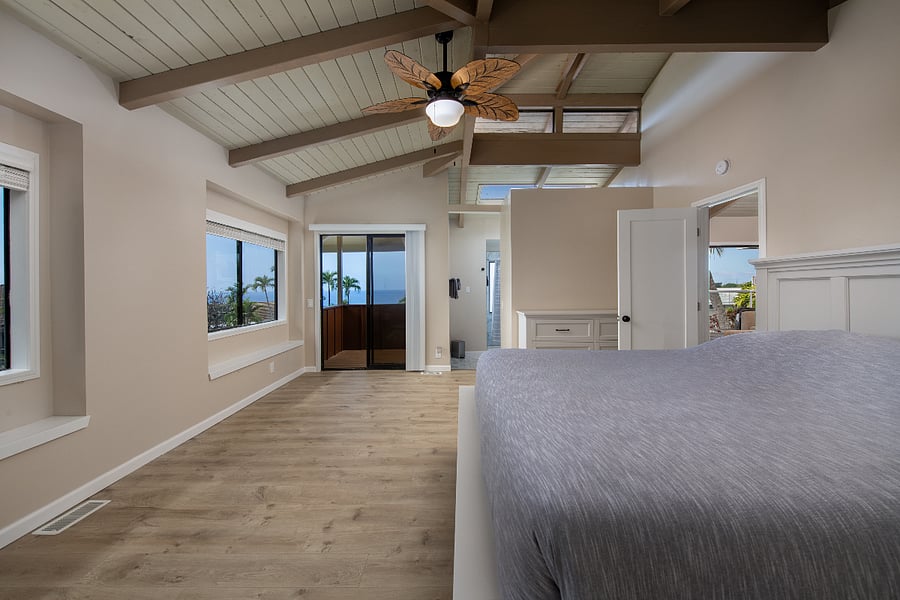 Spacious primary bedroom with king bed, private lanai, and peaceful atmosphere