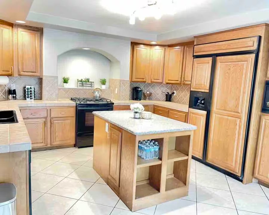 Fully equipped kitchen with island, ample storage, and modern appliances for long-term stays.