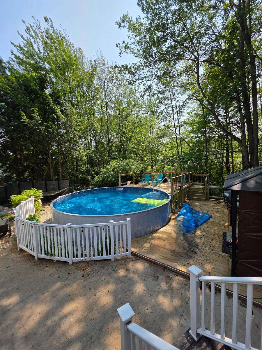 Back yard. Pool, hot tub and deck. There is a seating area with a tabletop fireplace and plenty of other seating around the house.
