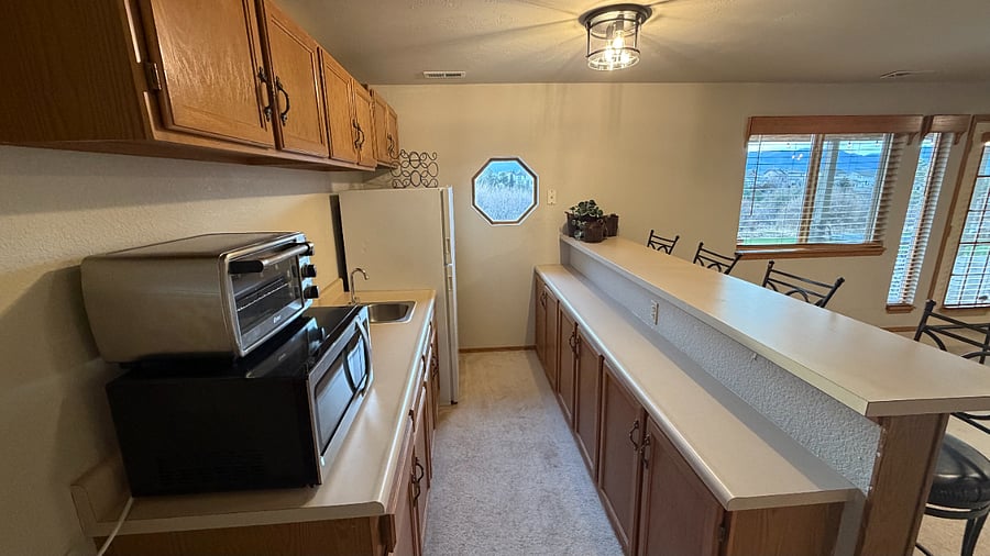 Stocked & functional kitchenette with fridge & freezer.