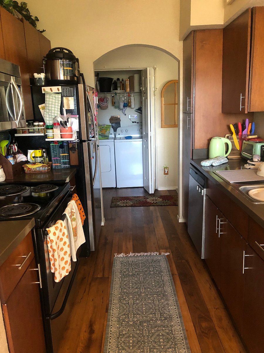 Full kitchen with electric oven, dishwasher, fridge and microwave. All cooking and dining utensils provided, along with various other cooking appliances like an electric kettle, stand mixer, and instant pot.