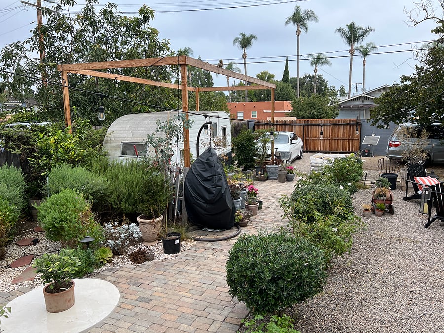 Gated property with parking in driveway out front for one car and two cars in back.
Vintage 1957 Westerner Tin can Trailer for show only.