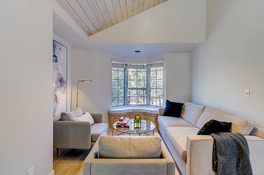 Cozy nook with a queen sofa bed and two accent chairs, ideal for board games or quiet conversations