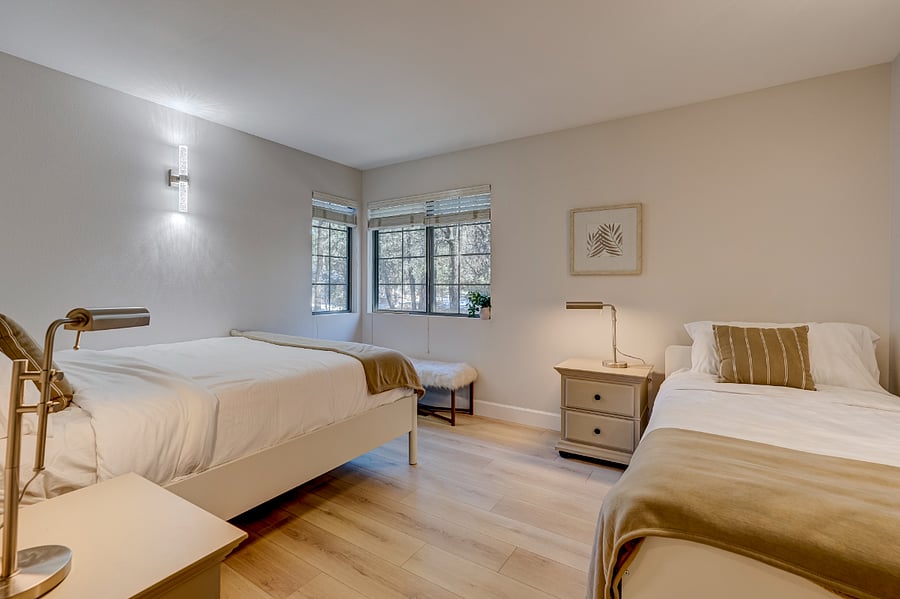 First bedroom featuring a queen-size bed and a twin trundle bed