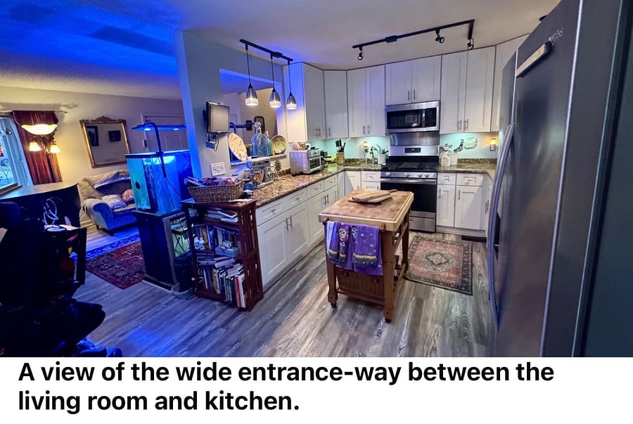 Our stainless and granite chefs kitchen, which is open through wide doorways and large, cutaway pass-though windows on botha sides