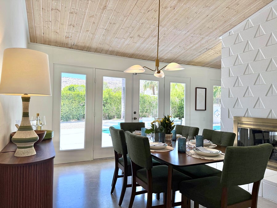 Dining area with access to pool deck, backyard and beautiful views.