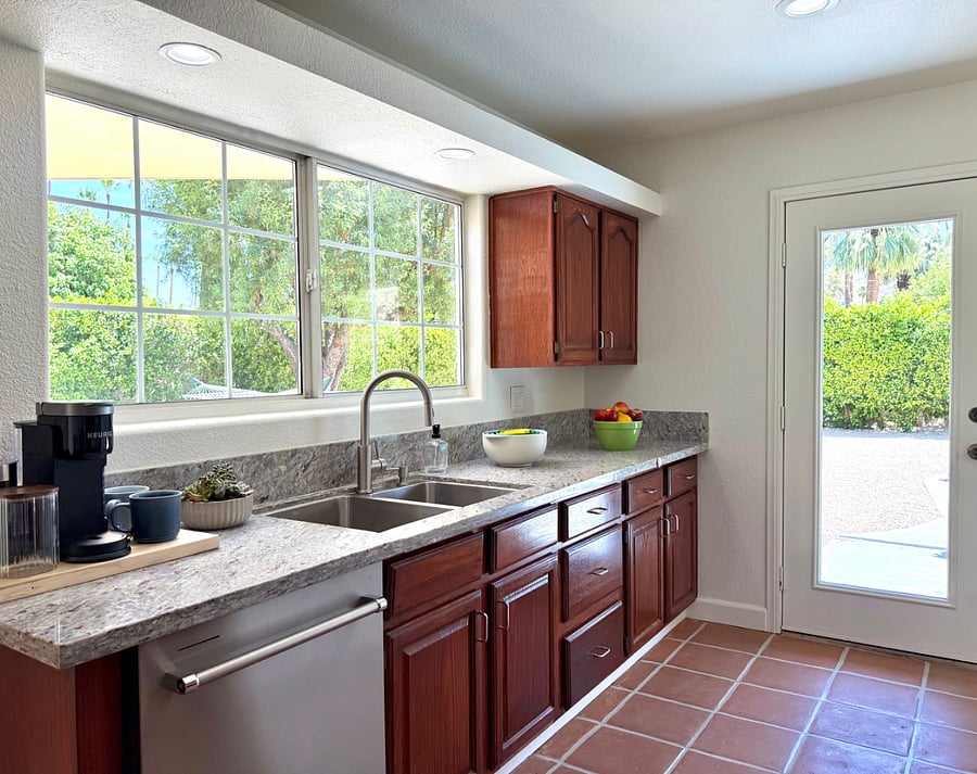 Bright kitchen with Keurig and drip coffee machines.