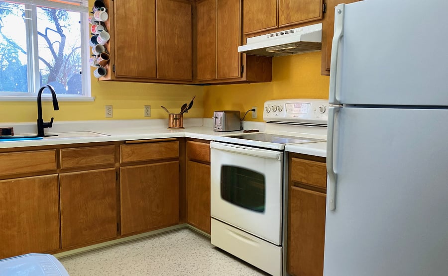 Kitchen with electric range and oven, sink and full size fridge