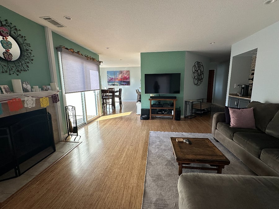 View from the couch's chaise of common areas and entry