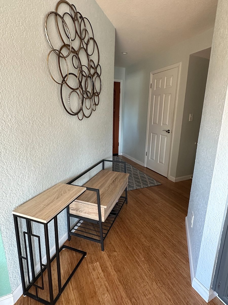 Main entrance to home with coat closet and entry bench