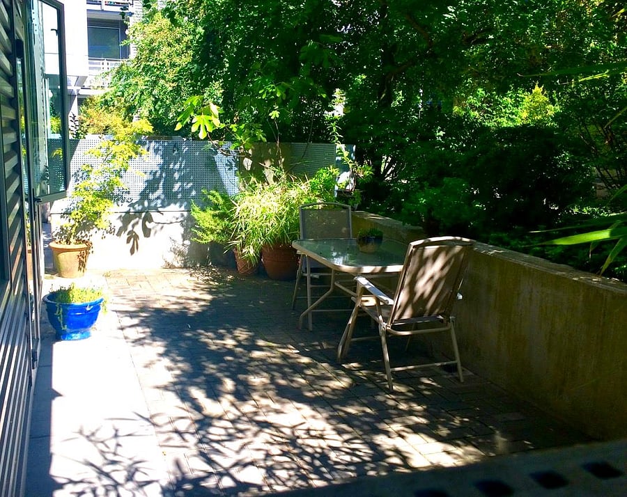 Private 200 sq ft patio surrounded by greenery