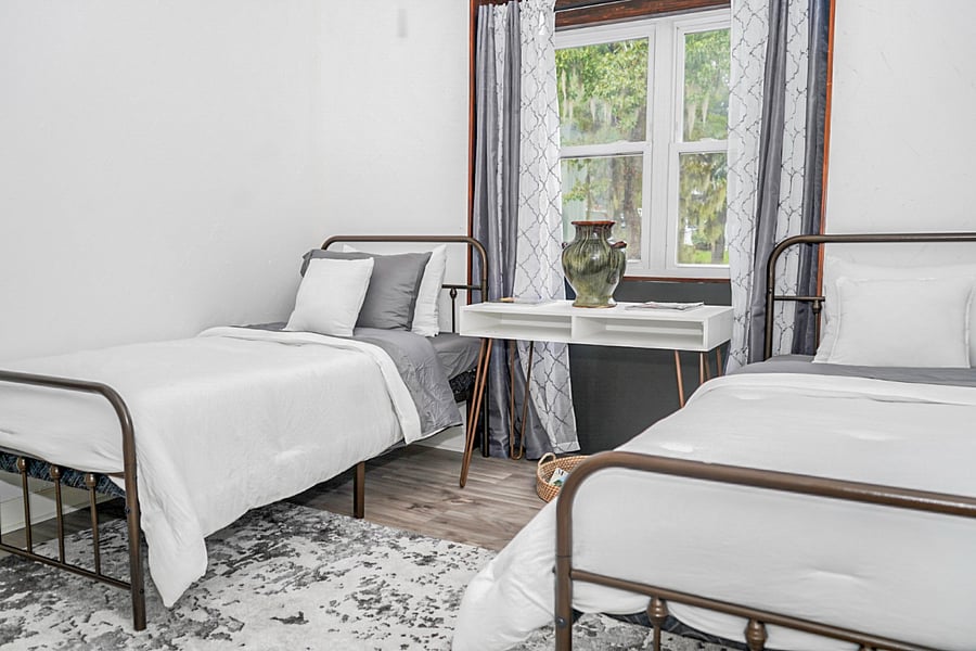 Comfortable twin bedroom offering a calm and welcoming space for restful nights.