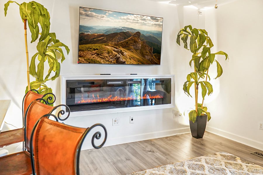 Cozy living space featuring a smart TV and electric fireplace for warm, relaxing evenings.