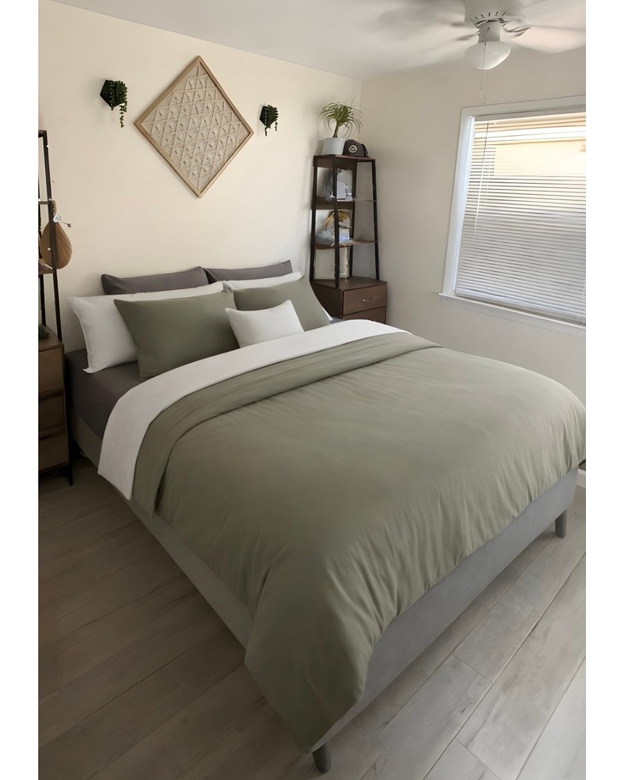 Cozy bedroom with queen size bed, wall mounted Smart TV, plenty of storage and fresh linens.
