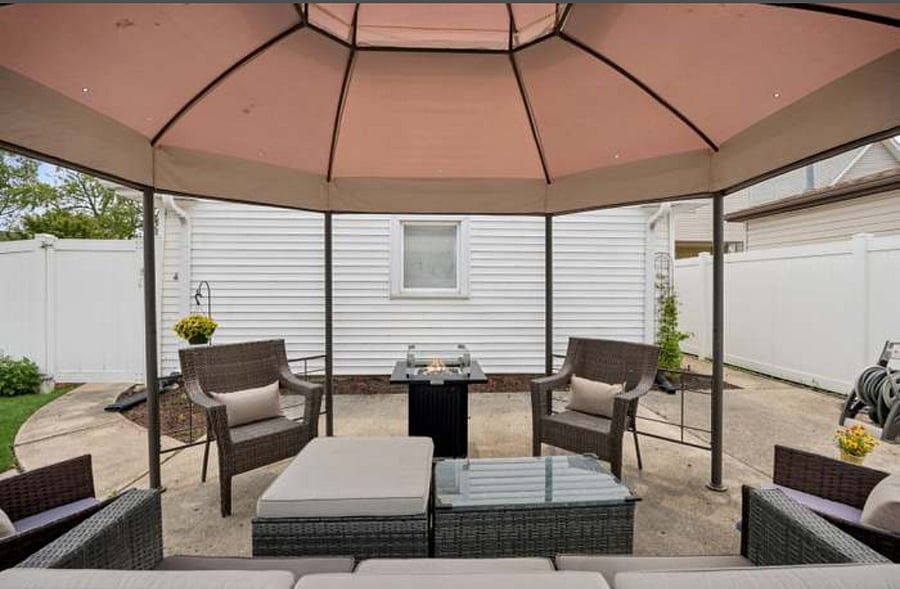 Back yard with canopy, seating area and gardens